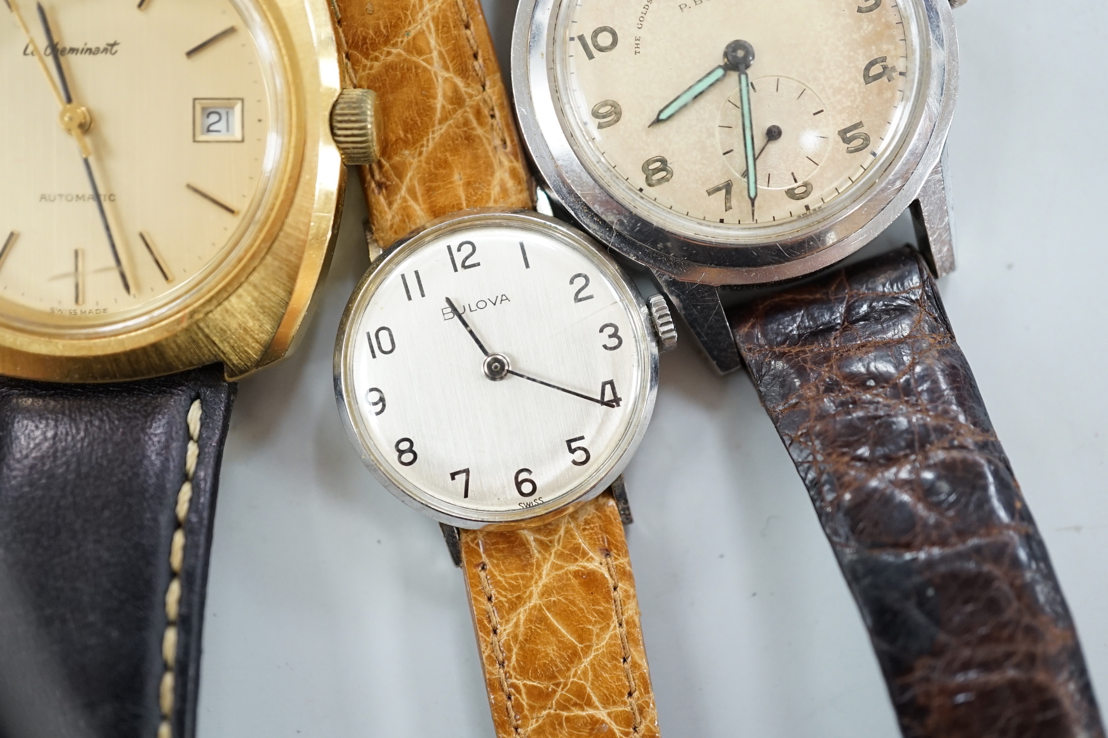 Three assorted gentleman's steel or gilt wrist watches, including retailed by Buhre and a lady's steel manual wind Bulova watch.